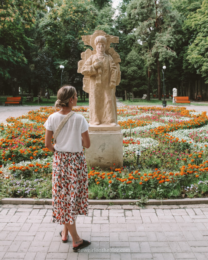 Me in front of a statue in Oak Park in Bishkek, Kyrgyzstan - 10 Best Things to Do in Bishkek