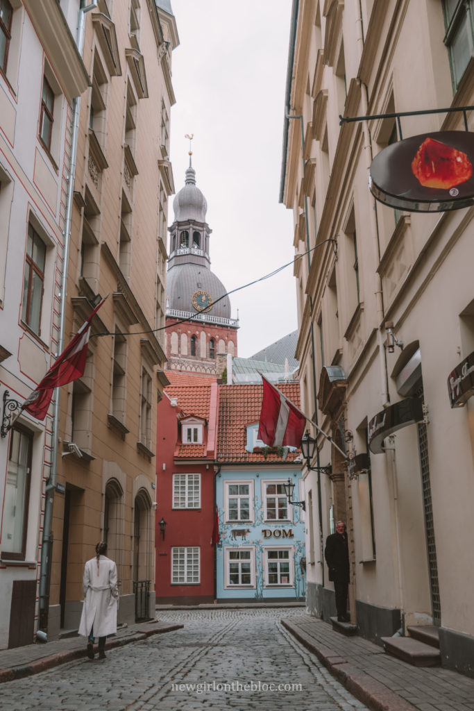 Narrow cobblestone street with the Blue House in Riga | 10 Best Things to Do in Riga, Latvia